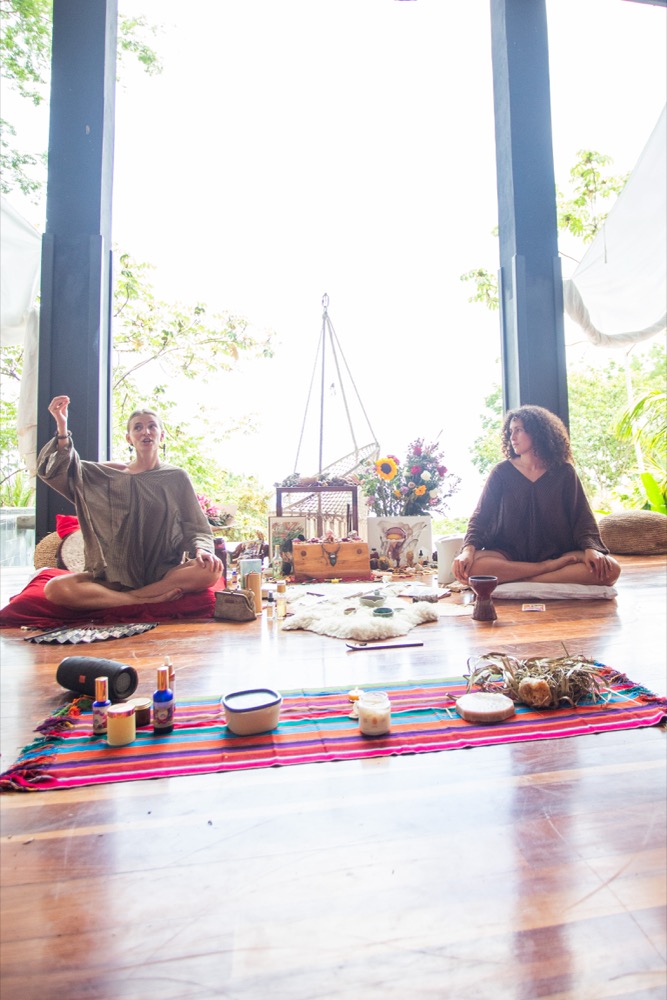 Bliss teaching at an altar during a training